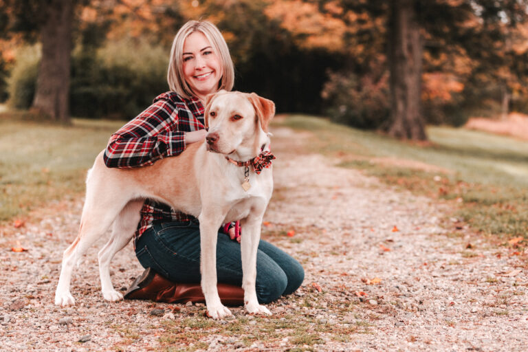 ct pet photographer featuring smiling woman with her dog in the woods professional pet photography